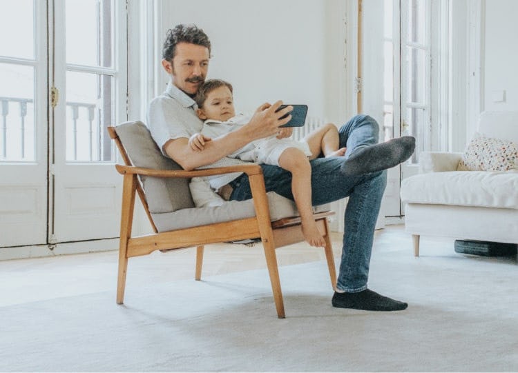 father and child using device