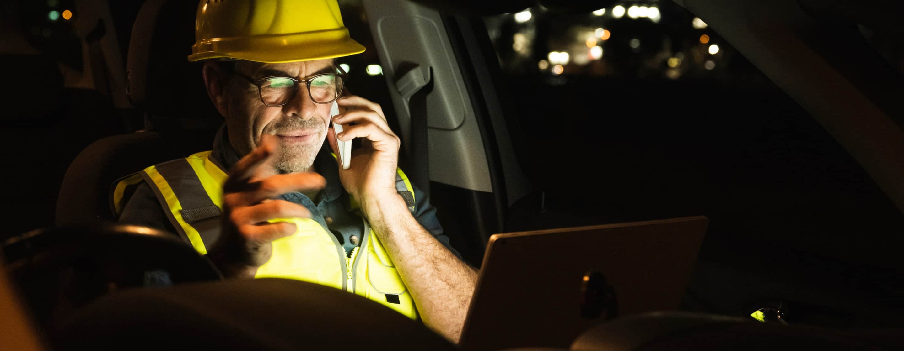 man using devices in vehicle